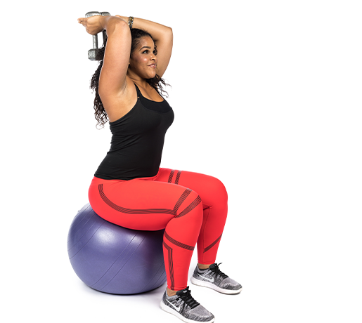 Person sitting on fitness ball with dumbbell 